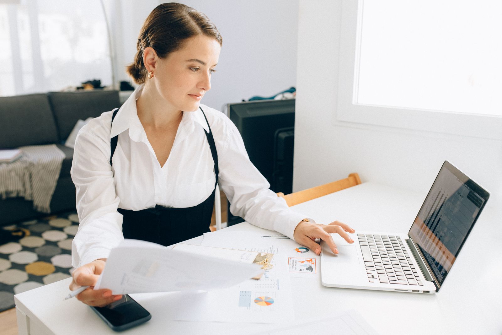 Analyst reviewing reports on a laptop