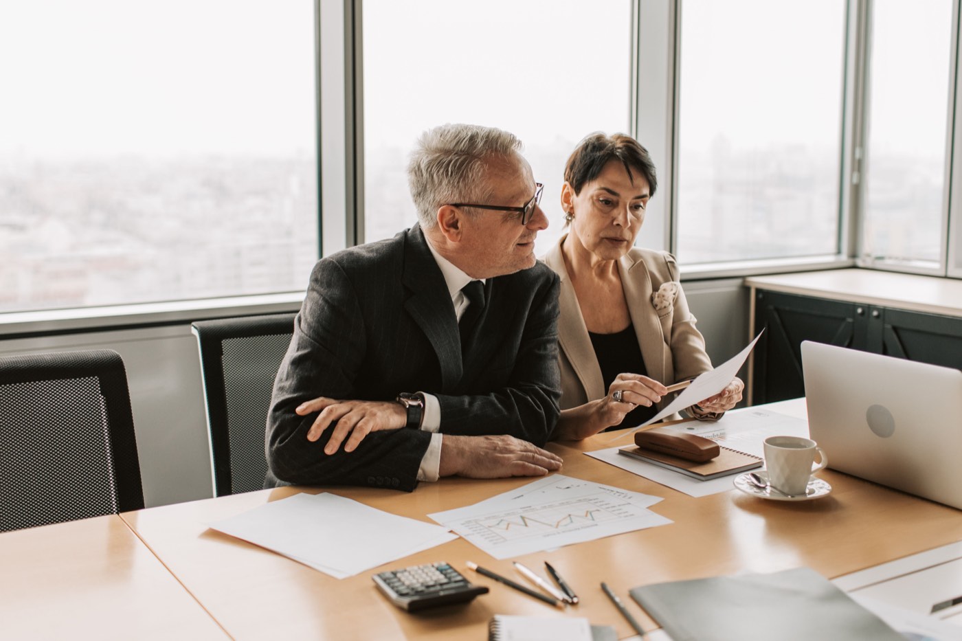Professionals reviewing documents at a meeting table